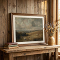 Sheep landscape print above a wooden desk