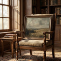 Countryside art above a leather armchair