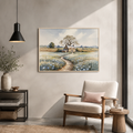 Stone cottage watercolor above a beige armchair