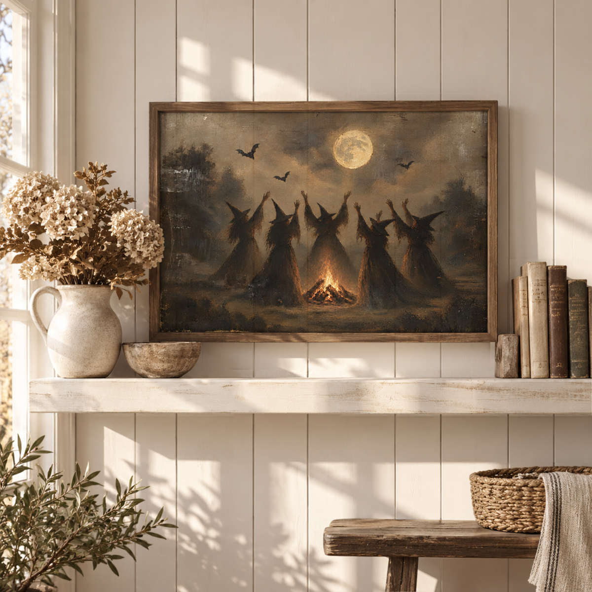 Full moon witches art above a white console with books