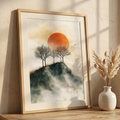 Vintage minimalist art of small trees on a misty mountain ridge under a large orange sun
