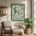 Seahorse print above a cream armchair with a plant