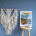 San Francisco watercolor print on a blue wall beside a macrame wall hanging