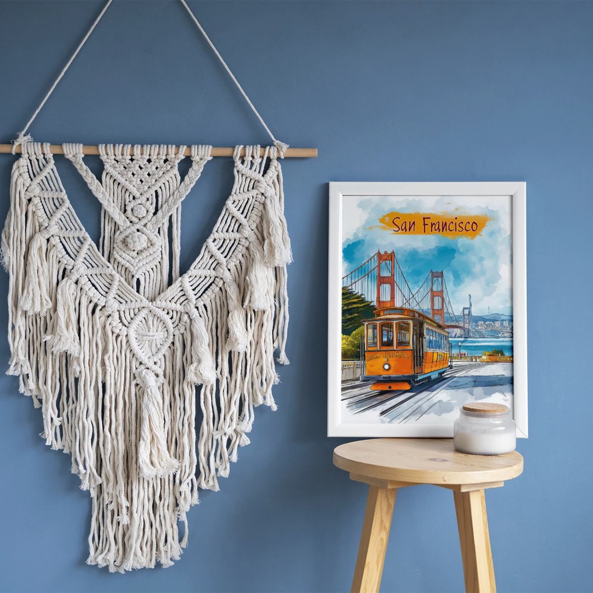 San Francisco watercolor print on a blue wall beside a macrame wall hanging