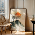 Mountain sunset print above a chair